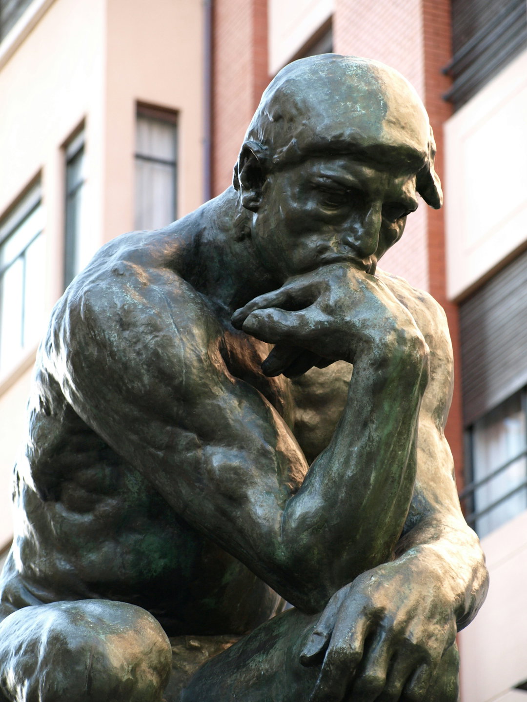 a-bronze-statue-of-a-man-with-his-hand-on-his-face.jpg a bronze statue of a man with his hand on his face